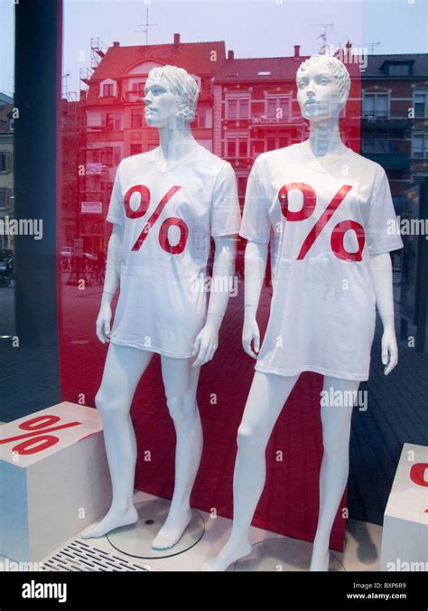 Mannequins in shop window Stock Photo - Alamy