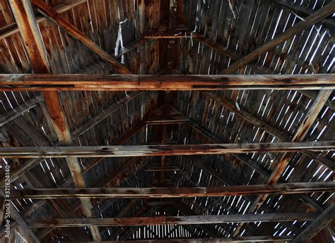 Rafter system in an old hangar. Roof with old gray wooden uprights and planks. Stock Photo ...