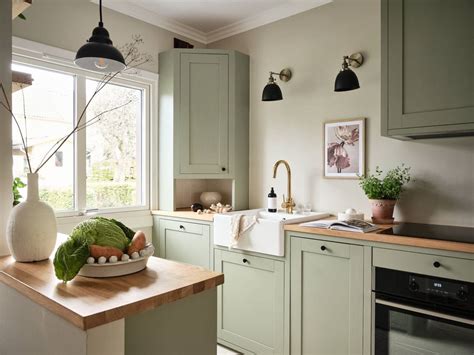 Sage green kitchen cabinets in a green color palette apartment - COCO ...