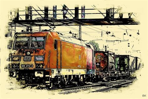 an orange train traveling down tracks next to a tall metal structure with wires above it