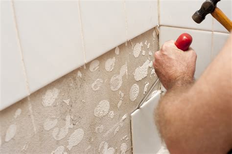 Free Stock Photo 10184 Man removing old wall tiles | freeimageslive