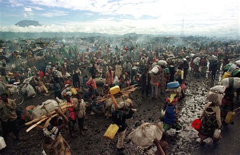 File photo of Rwandan Hutu refugees resting on the side of the road ...