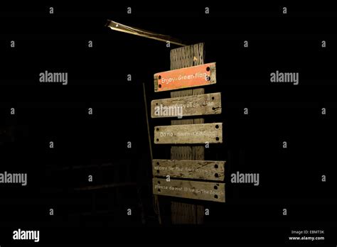 wooden sign post at night Stock Photo - Alamy