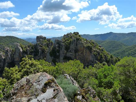 the rocky mountains are covered with trees and bushes