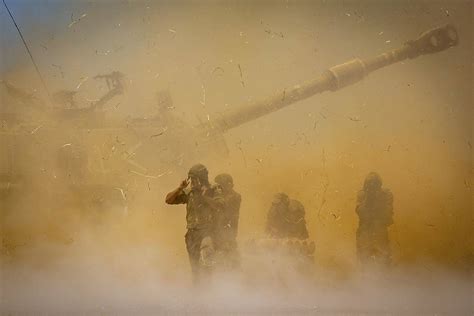 An Israeli artillery unit fires toward targets in Gaza Strip, at the ...