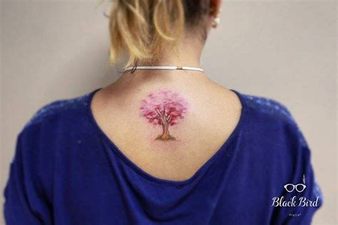 Pink tree tattoo on the upper back.