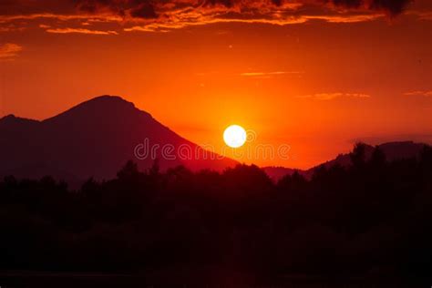 A Beautiful, Colorful Sunset Over the Mountains, Lake and Forest in ...