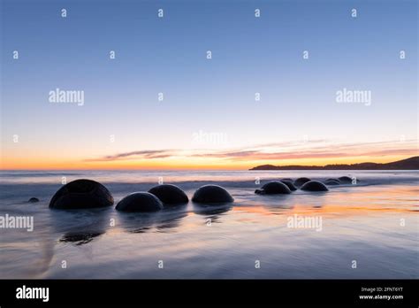 Moeraki boulders at sunrise Stock Photo - Alamy