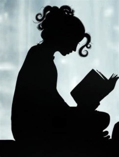 the silhouette of a woman reading a book