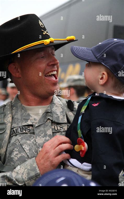 Staff Sgt. Gordon Cairns of B Troop 2nd Squadron, 107th Cavalry Regiment holds his 18-month-old ...