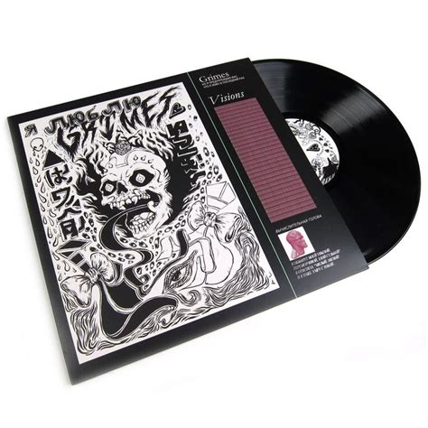 a black and white album with an image of a skull on the cover, in front ...