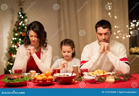 Family Praying before Meal at Christmas Dinner Stock Photo - Image of ...