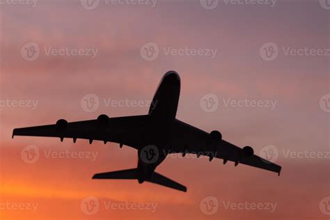 Black silhouette of plane on sunset background 13836109 Stock Photo at Vecteezy