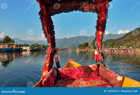 Beautiful View of Shikara Boat Ride on Dal Lake with Houseboats and Mountain Background at ...