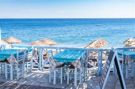 Premium Photo | Restaurant terrace in front of the beach in kamari on the island of santorini