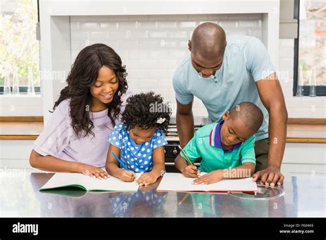 Parents helping children doing homework Stock Photo - Alamy