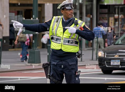 A male New York City Traffic Enforcement Officer directing cars at East ...