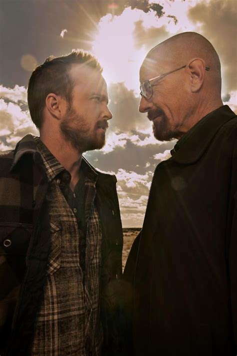 two men standing next to each other with the sun shining behind them and clouds in the sky