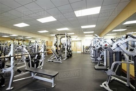 Exercise equipment in empty gym - Stock Photo - Dissolve