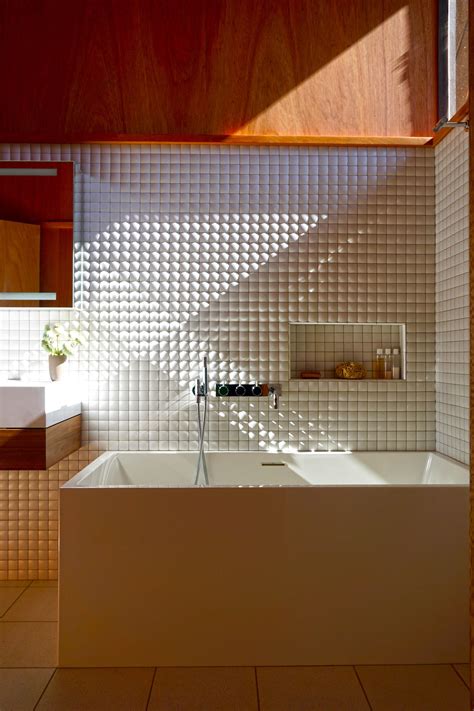 Minimal midcentury bath. Mahogany paneling, Ann Sacks Context pillow mosaic tile, Wetstyle Cube ...