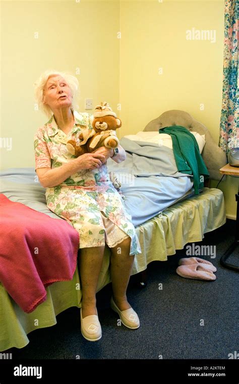 sad old lady in nursing home with senile dementia sitting on edge of Stock Photo, Royalty Free ...