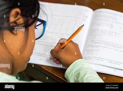 Young girl child writing with pencil Stock Photo - Alamy