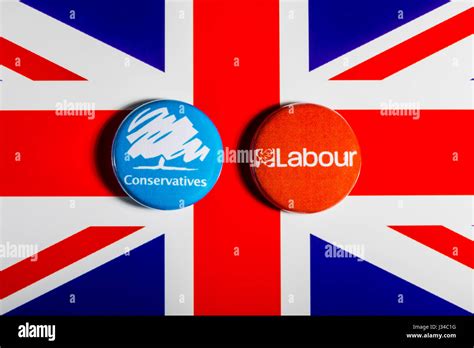 LONDON, UK - MAY 2ND 2017: Conservative and Labour Party pin badges over the UK flag ...