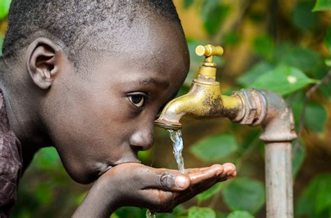 Water Is Life African Baby Boy Drinking Water Stock Photo - Download Image Now - iStock