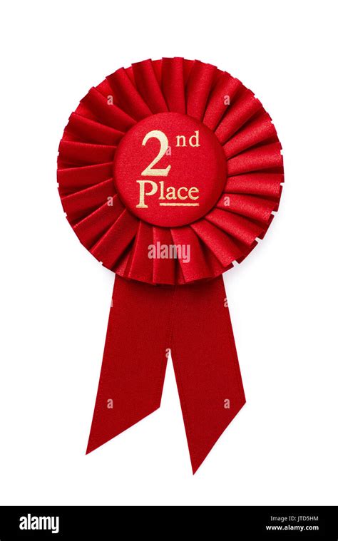 Red 2nd place ribbon rosette with gold central text in a pleated surround isolated on white ...