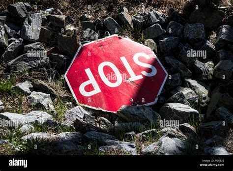 An abandoned broken stop sign thrown into the rocks Stock Photo - Alamy