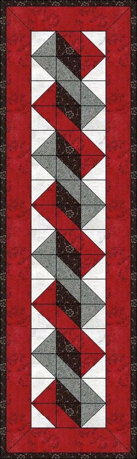 a red and grey quilt with black border