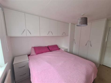 Corner Wardrobes Double Wardrobes And Top Box Storage In A Double Bedroom.