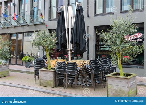 Folded Cafe Tables and Chairs and Closed Sun Umbrellas Editorial Stock Image - Image of modern ...
