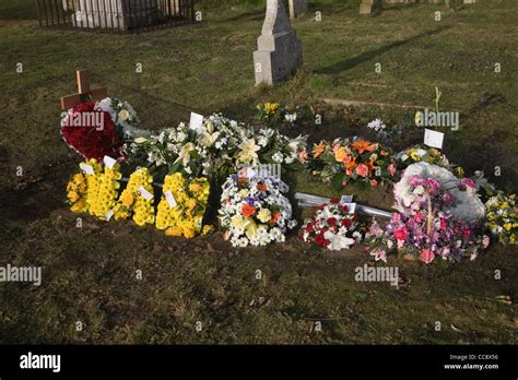 Bunches of flowers on grave Stock Photo - Alamy