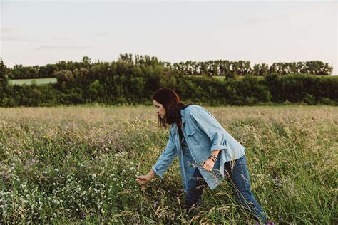 "Woman Picking Wild Flowers From Field" by Stocksy Contributor "Carey ...