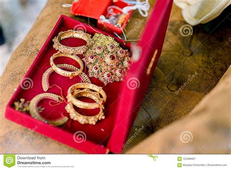 Beautiful Golden Bracelets and Rings on Bed. Wedding Gold Bangles and Bracelets Stock Image ...