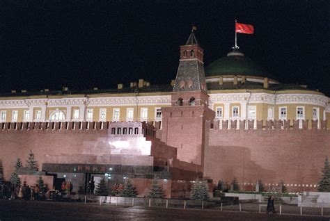 A nighttime view in Red Square showing the Lenin Mausoleum. Behind the ...