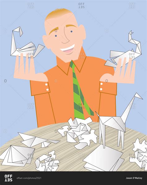 Man holding origami figures in hand stock photo - OFFSET