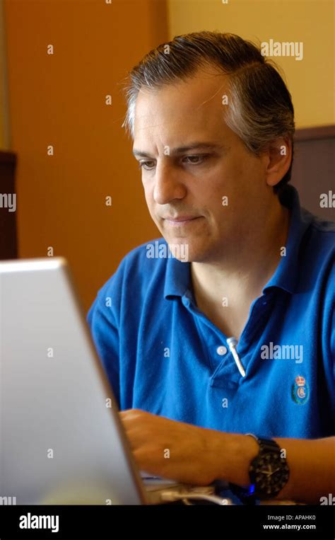 man using a laptop computer in a coffee shop Stock Photo - Alamy