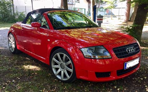 a red convertible car parked in front of a house