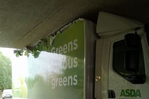 Asda truck driver gets stuck under a bridge...blocking the road to ...