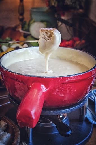 Delicious Swiss Cheese Fondue In A Pot Served With Bread Stock Photo - Download Image Now - iStock