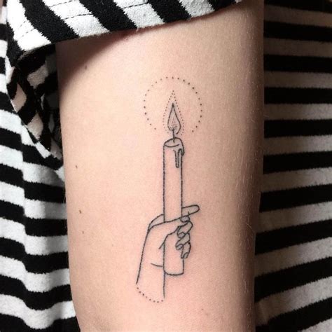 A tattoo of a hand holding a candle inked on the arm | Candle tattoo ...