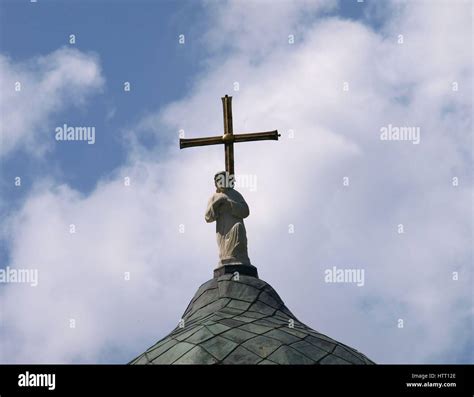 Sculpture of Jesus on church's roof Stock Photo - Alamy