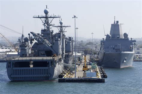 The amphibious dock landing ships USS Pearl Harbor (LSD-52) and USS Rushmore (LSD-47)*rear ...