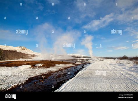 Several Geysers in a snowy winter landscape with blue sky in Iceland Stock Photo - Alamy