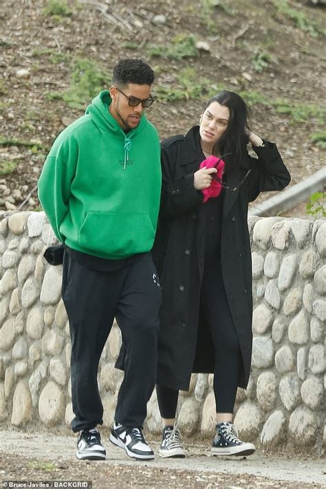 Pregnant Jessie J wraps her baby bump in a black coat as she cosies up ...