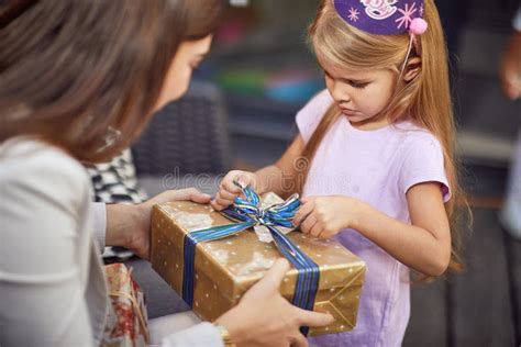 Child Girl Opening Birthday Gift. Birthday Party at Home Stock Image ...