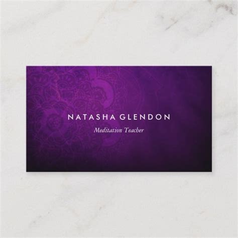 a purple business card with an intricate design