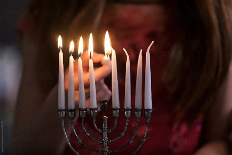 "Hanukkah: Girl Lighting Candles With Shamash" by Stocksy Contributor ...